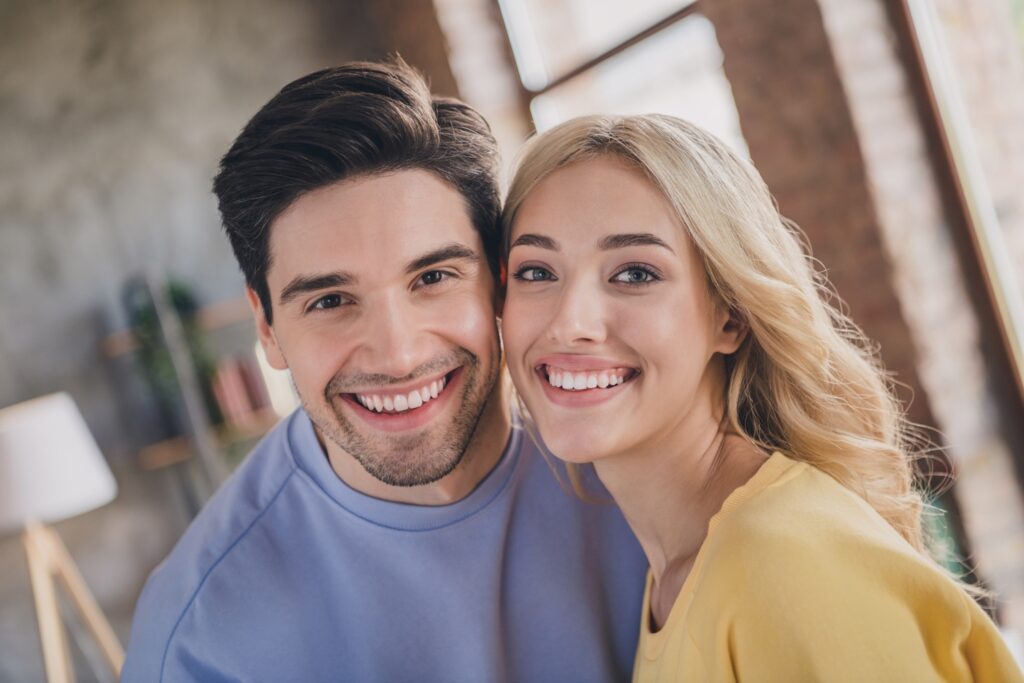 Smiling couple showing healthy confident smiles after visiting a Lynnwood dentist